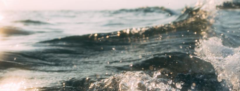 photo of an ocean wave on a sunny clear skied day