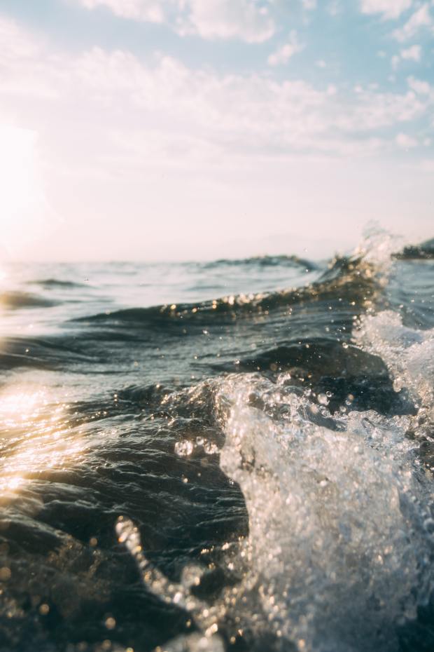 photo of an ocean wave on a sunny clear skied day