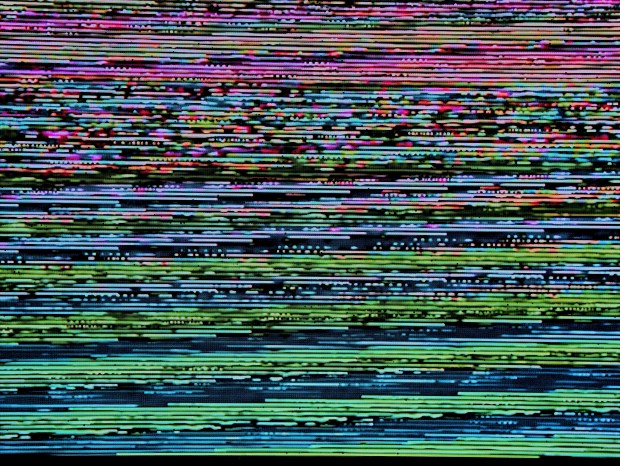 Glitchy television screen with colourful haphazard lines in pink, purple, and green.